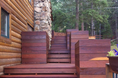 Inspiration for a large craftsman backyard deck container garden remodel in Denver with no cover