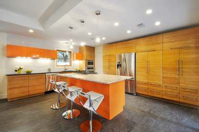 Example of an eclectic l-shaped kitchen design in Austin with flat-panel cabinets, medium tone wood cabinets, white backsplash, subway tile backsplash and stainless steel appliances