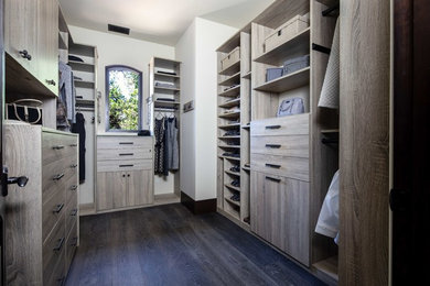 Large contemporary gender-neutral walk-in wardrobe in San Francisco with flat-panel cabinets, medium wood cabinets, dark hardwood floors and brown floor.