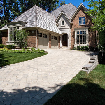Traditional Brick and Stone Glencoe Residence with Carriage Style Garage Doors