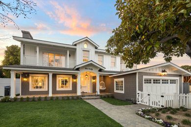 Beach style multicolored two-story concrete fiberboard and board and batten exterior home photo in San Diego with a shingle roof and a gray roof