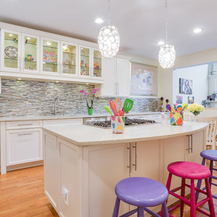 Large transitional kitchen pantry appliance - Example of a large transitional l-shaped light wood floor kitchen pantry design in Louisville with an island, a single-bowl sink, recessed-panel cabinets, white cabinets, quartz countertops, multicolored backsplash, mosaic tile backsplash and stainless steel appliances
