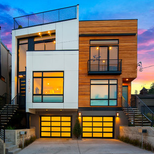 シアトルのコンテンポラリースタイルのおしゃれな三階建ての家 (陸屋根、デュープレックス) の写真