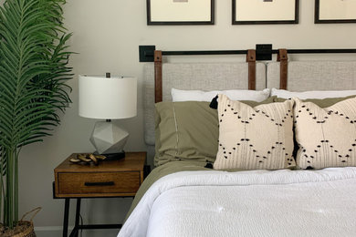 Bedroom - mid-sized industrial guest carpeted and beige floor bedroom idea in Charlotte with white walls