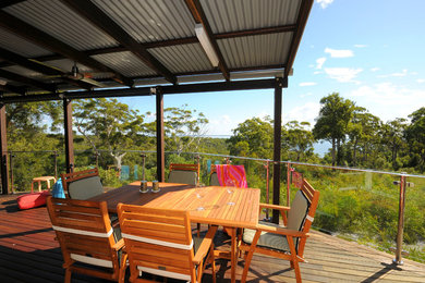 Photo of a beach style patio in Sunshine Coast with decking and a pergola.