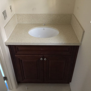 Antique Cherry glaze kitchen & bathroom cabinets and sparking Quartz countertops
