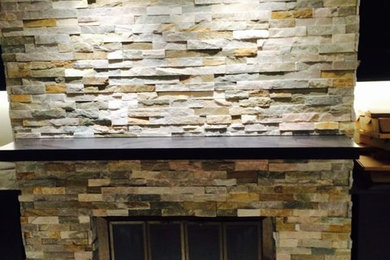 Inspiration for a mid-sized timeless open concept beige floor living room remodel in Other with a standard fireplace and a stone fireplace