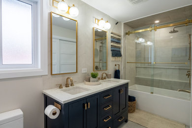 Bathroom - mid-sized contemporary beige tile and ceramic tile porcelain tile, gray floor and double-sink bathroom idea in Ottawa with shaker cabinets, blue cabinets, beige walls, an undermount sink, quartz countertops, beige countertops, a niche and a freestanding vanity