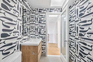 Bathroom - mid-sized transitional kids' beige tile and ceramic tile ceramic tile, beige floor, single-sink and wallpaper bathroom idea in New York with flat-panel cabinets, beige cabinets, a one-piece toilet, blue walls, a vessel sink, quartz countertops, white countertops and a freestanding vanity