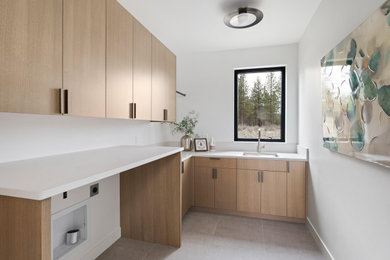 Inspiration for a modern laundry room remodel in Other with flat-panel cabinets