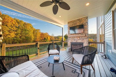 Small minimalist backyard second story wood railing deck photo in Philadelphia with a fireplace and a roof extension