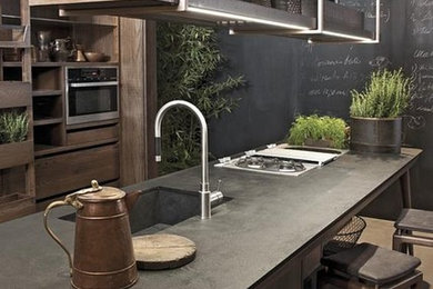 Example of a mid-sized mountain style single-wall open concept kitchen design in Barcelona with an integrated sink, flat-panel cabinets, medium tone wood cabinets, stainless steel appliances and an island
