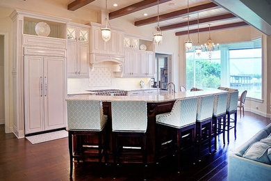 Inspiration for a mid-sized transitional l-shaped open plan kitchen in Orlando with raised-panel cabinets, white cabinets, panelled appliances, with island and an undermount sink.