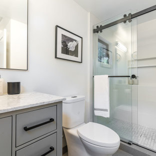 Example of a small classic master white tile and porcelain tile gray floor and single-sink sliding shower door design in Sacramento with flat-panel cabinets, gray cabinets, white walls, a drop-in sink, quartz countertops, white countertops and a floating vanity