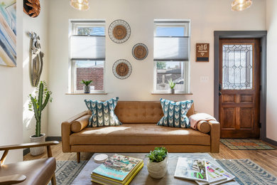 Example of a small southwest formal and enclosed medium tone wood floor and brown floor living room design in Other with white walls, no fireplace and a tv stand