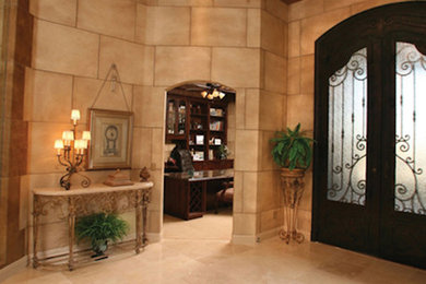 Marble floor entryway photo in Louisville with beige walls and a dark wood front door