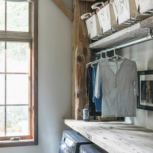 Design ideas for a medium sized rustic separated utility room in Other with open cabinets, medium wood cabinets, wood worktops, white walls, dark hardwood flooring, a side by side washer and dryer and grey floors.