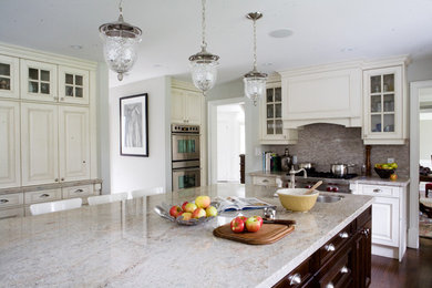 Example of a classic kitchen design in Toronto with glass-front cabinets, stainless steel appliances, white cabinets and granite countertops