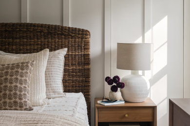 Example of a mid-sized transitional guest vinyl floor, brown floor and wall paneling bedroom design in DC Metro with white walls