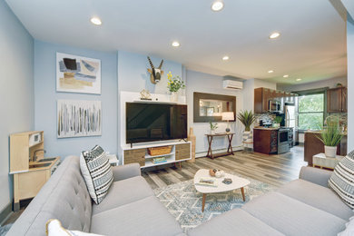 Example of a mid-sized trendy formal and open concept gray floor living room design in Other with blue walls, no fireplace and a tv stand