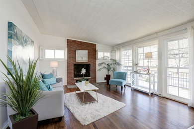 Large minimalist formal and open concept dark wood floor living room photo in DC Metro with gray walls, a standard fireplace and a brick fireplace