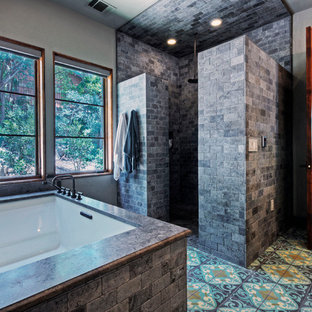 Tuscan bathroom photo in Austin with an undermount tub