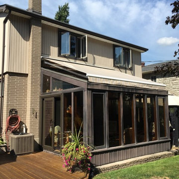 Retractable awning over solarium