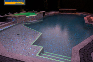 Pool fountain - huge traditional backyard concrete paver and custom-shaped pool fountain idea in Montreal