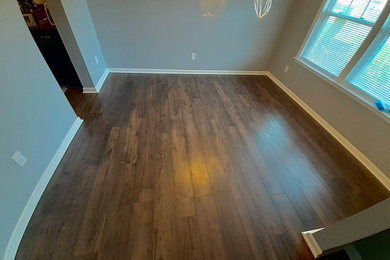 Inspiration for a large vinyl floor and brown floor dining room remodel in Charlotte