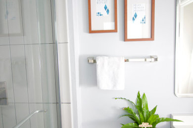 Example of a small trendy master gray tile and ceramic tile porcelain tile, blue floor and single-sink bathroom design in DC Metro with gray cabinets, a two-piece toilet, gray walls, an integrated sink, solid surface countertops, white countertops and a freestanding vanity
