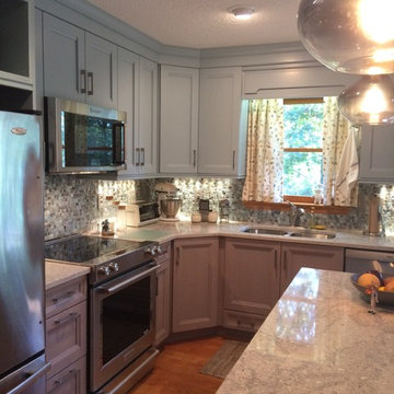 Blue wall cabinets, grey base cabinets... All of it beautiful and functional