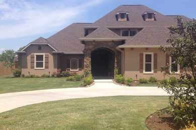 Large transitional beige three-story mixed siding exterior home idea in New Orleans with a hip roof