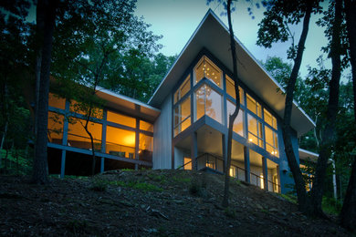 Large trendy two-story mixed siding exterior home photo in DC Metro with a shed roof