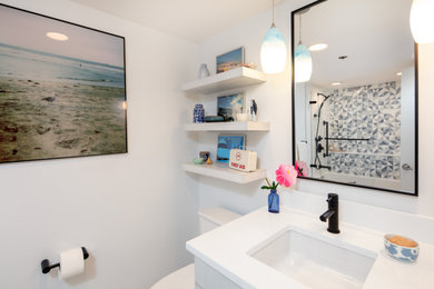 Small modern 3/4 bathroom in Seattle with flat-panel cabinets, white cabinets, an alcove tub, an alcove shower, a one-piece toilet, blue tile, glass tile, white walls, terrazzo floors, an undermount sink, engineered quartz benchtops, grey floor, an open shower, white benchtops, a single vanity and a floating vanity.