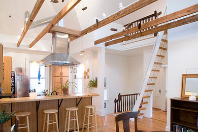 Large cottage u-shaped light wood floor eat-in kitchen photo in Boston with an undermount sink, flat-panel cabinets, medium tone wood cabinets, wood countertops, stainless steel appliances and an island