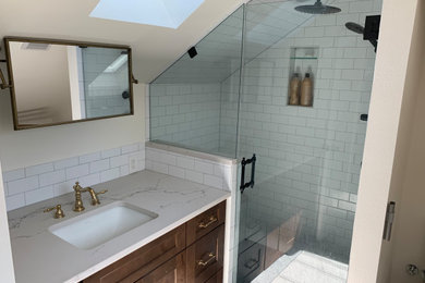 Bathroom - mid-sized white tile and subway tile marble floor, single-sink and vaulted ceiling bathroom idea in Austin with a bidet, an undermount sink, quartz countertops, a hinged shower door and white countertops