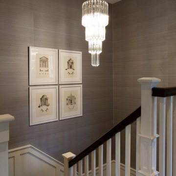 Landing with artwork from Eichholtz, feature chandelier, Casamance wallpaper