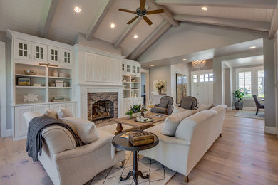 Living room - contemporary open concept light wood floor living room idea in Boise with gray walls and a brick fireplace