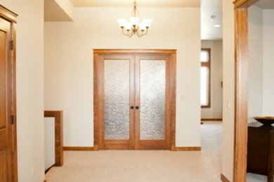Example of an arts and crafts porcelain tile entryway design in Seattle