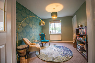 This is an example of a medium sized classic enclosed living room feature wall in Surrey with a reading nook, green walls, carpet, no fireplace, no tv and brown floors.