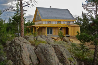 Mid-sized arts and crafts yellow two-story wood gable roof photo in Denver