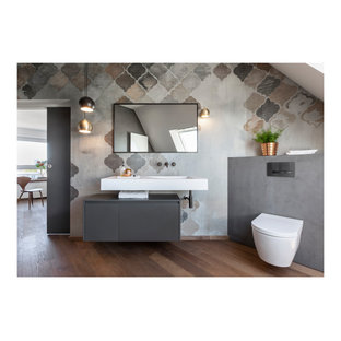 Mid-sized shabby-chic style 3/4 bathroom in Frankfurt with flat-panel cabinets, grey cabinets, a curbless shower, a two-piece toilet, grey walls, dark hardwood floors, a console sink, solid surface benchtops, brown floor, an open shower, white benchtops, a niche, a single vanity, a floating vanity, wallpaper and wallpaper.