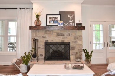 Inspiration for a mid-sized timeless open concept light wood floor and beige floor family room remodel in Other with gray walls, a standard fireplace, a stone fireplace and a corner tv