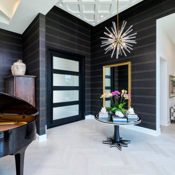 Black grasscloth wraps the entry and adjoining piano lounge