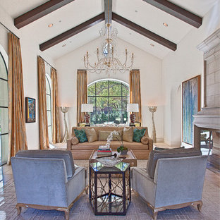 Inspiration for an expansive mediterranean formal open plan living room in Dallas with white walls, limestone flooring, a standard fireplace, a stone fireplace surround and no tv.