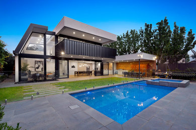 Design ideas for a mid-sized modern backyard rectangular pool in Melbourne with a hot tub and concrete pavers.