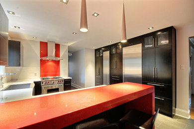 Inspiration for a mid-sized modern u-shaped porcelain tile open concept kitchen remodel in Ottawa with a farmhouse sink, flat-panel cabinets, dark wood cabinets, quartz countertops, white backsplash, subway tile backsplash and stainless steel appliances