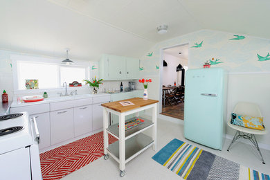 Inspiration for an eclectic separate kitchen in Other with an integrated sink and coloured appliances.