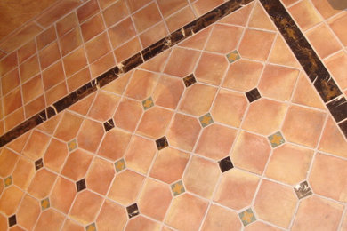 Foyer - mid-sized mediterranean ceramic tile and red floor foyer idea in Sacramento with beige walls