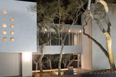 Example of a large beach style beige two-story stucco exterior home design in Other
